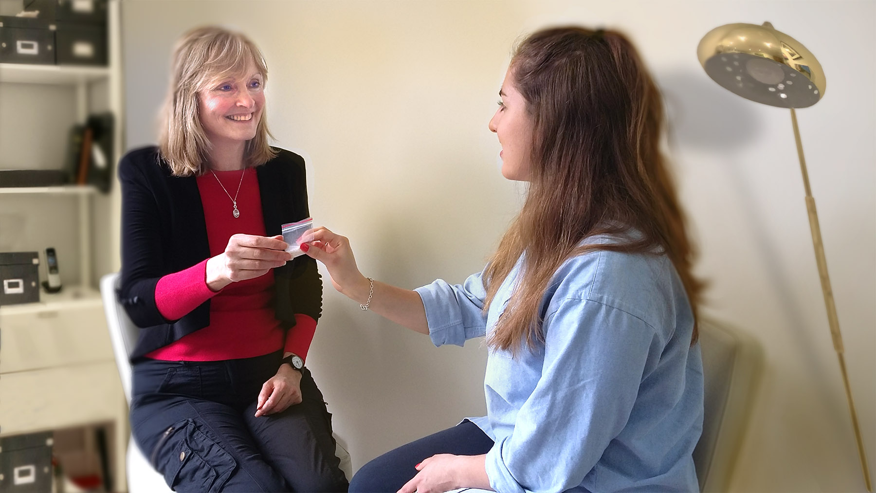 Felicity Stewart giving a homeopathic medicine to a patient