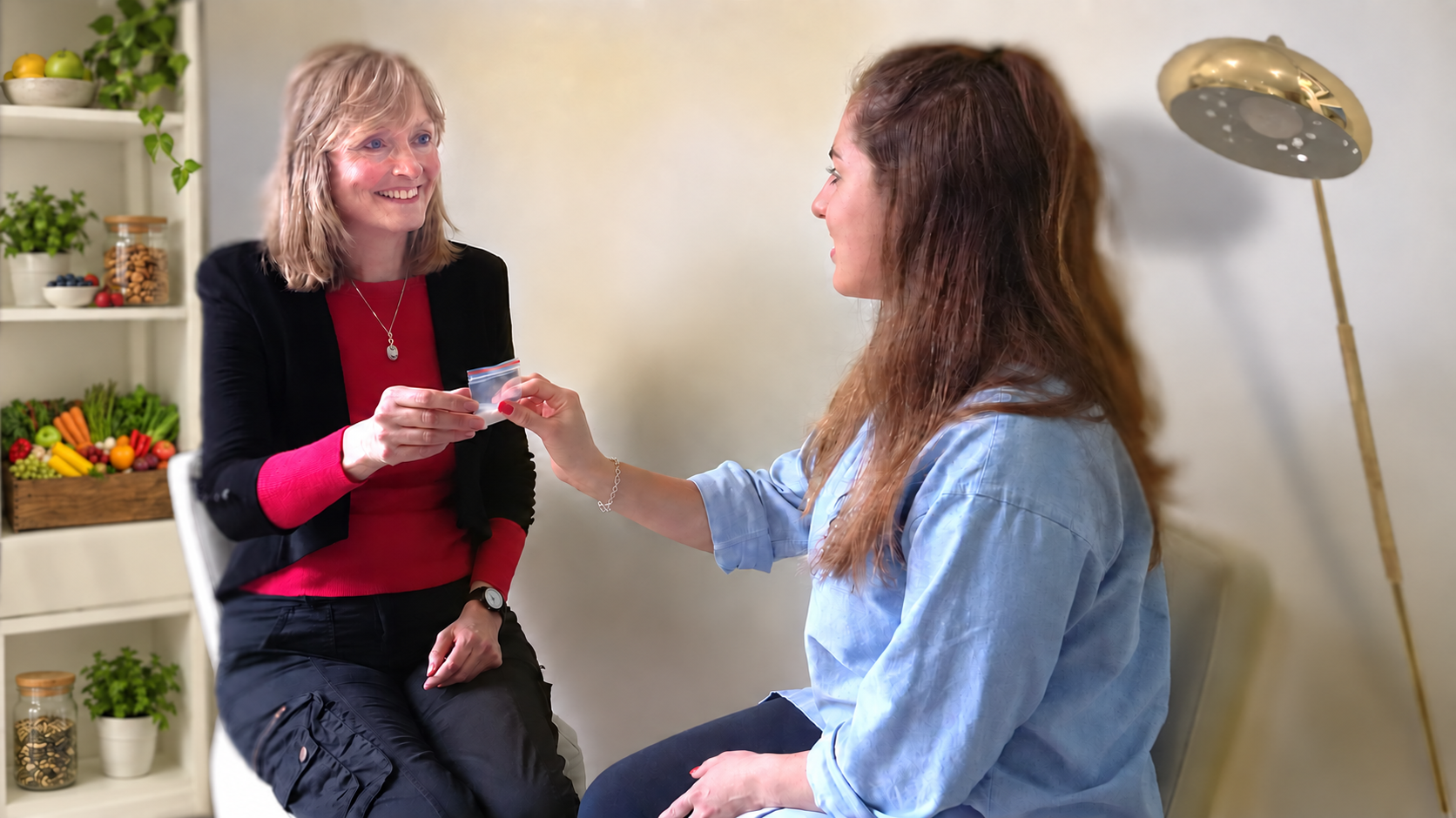 Felicity Stewart consulting with a patient, with healthy foods displayed on the shelves